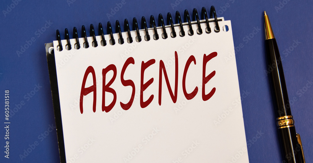ABSENCE - word in a white notebook on a blue background with a pen ABSENCE - word in a white notebook on a blue background with a pen
