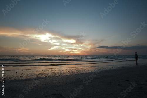 Sunset dark at Florida beach. Calm water with yellow sky from sun. 