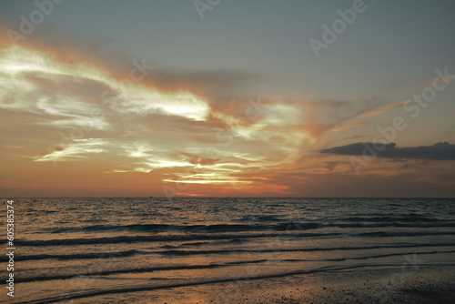 Sunset dark at Florida beach. Calm water with yellow sky from sun. © Del Harper