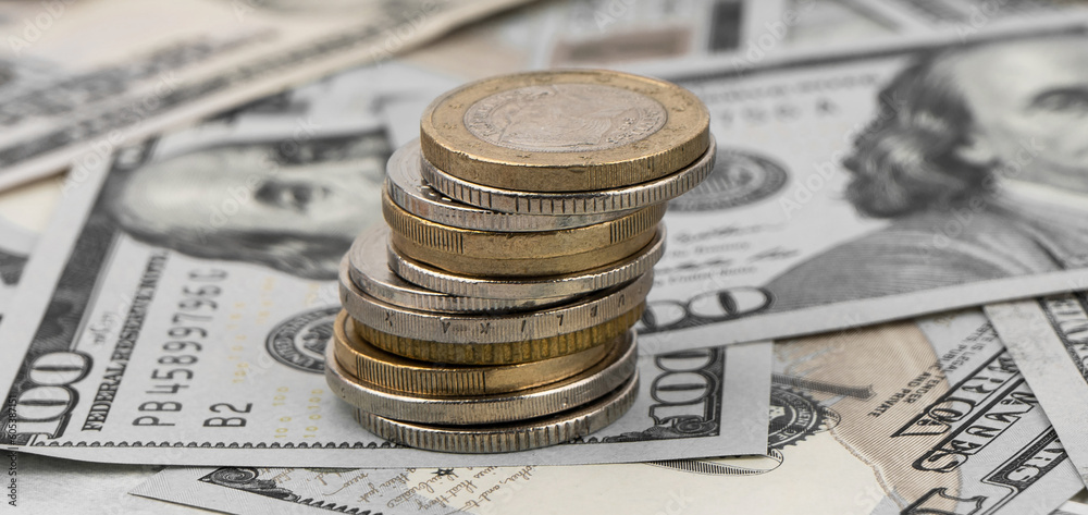 Stack of golden coins on dollar bills on a table. Stack of golden coins on dollar bills on a table.