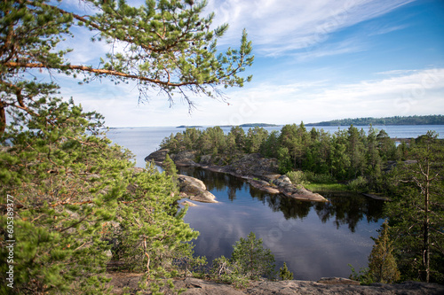 Granite island of Sortavaly in summer under a blue sky. Top view of the lake and the stone islands