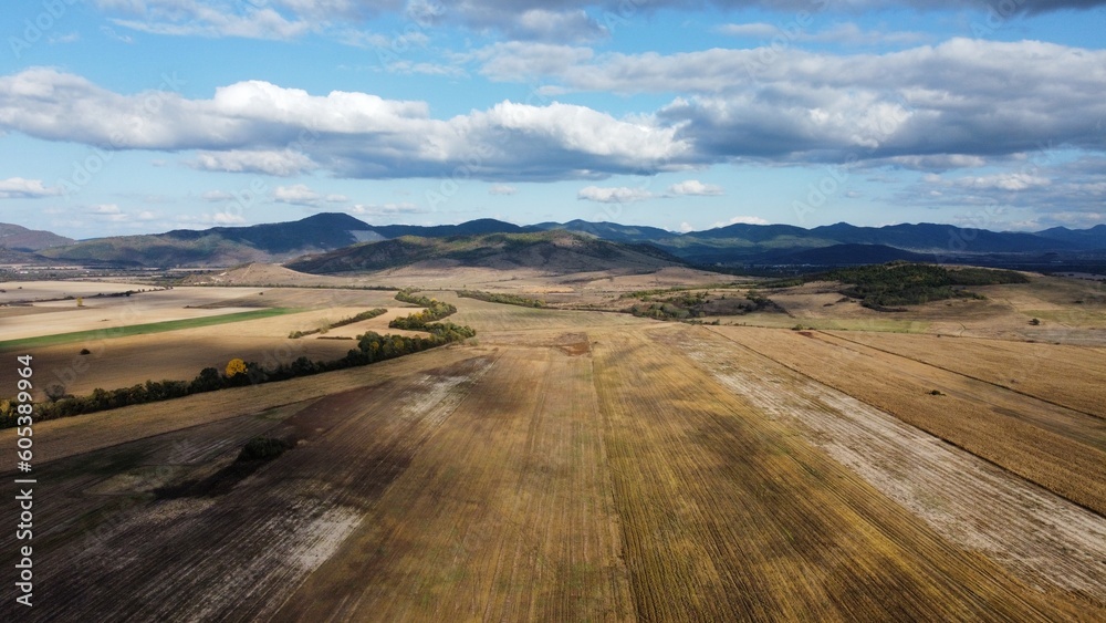 Aerial distant view of Balkan mountain range ( Also known as Stara planina ) and agricultural field.