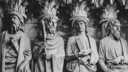 Sculptural images of the Holy Apostles on the wall of the facade of Saint Fin Barre's Cathedral in Cork, Ireland. The Apostles Andrew, James major, Thomas, Matthias. Monochrome.