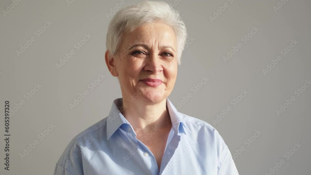 Confident stylish european middle aged senior woman. Older mature 60s lady smiling in white background. Happy attractive senior female looking camera close up face headshot portrait. Happy people