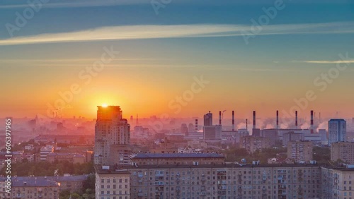 Residential buildings on Leninskiy avenue, Stalin skyscrapers, smoking pipes and panorama of city at sunrise timelapse in Moscow, Russia. Morning mist and colorfil sky. Aerial view from rooftop photo