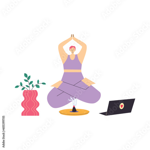 Yong woman watching online yoga classes on laptop, practicing yoga at home.