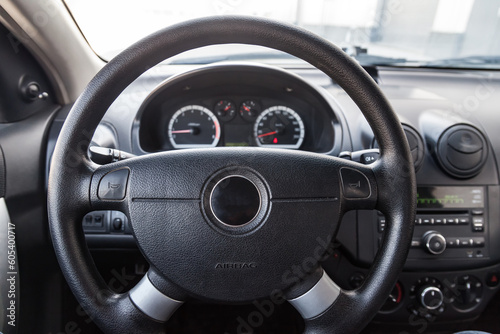 Interior view with steeering wheel and dashboard of luxury very expensive new white car stands in the washing box after detailing in vehicle repair workshop © Aleksandr Kondratov