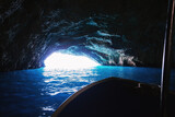 Passenger boat sailing inside Blue Cave in Montenegro. Famous sea cave in Adriatic sea.