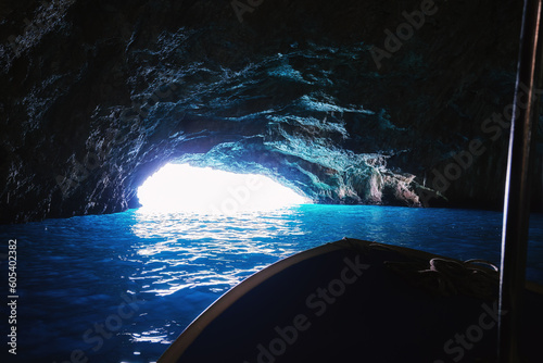 Passenger boat sailing inside Blue Cave in Montenegro. Famous sea cave in Adriatic sea.