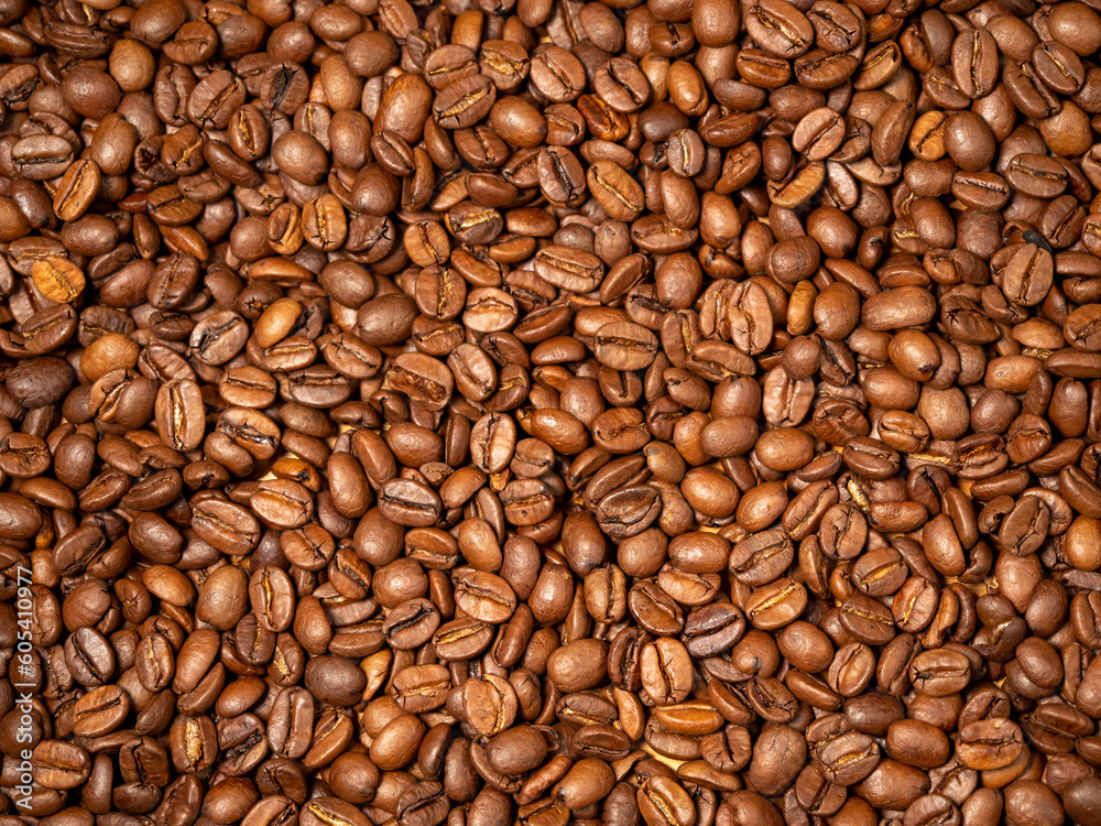 Fototapeta premium Background from roasted coffee beans. Scattered coffee beans. Coffee beans close up.