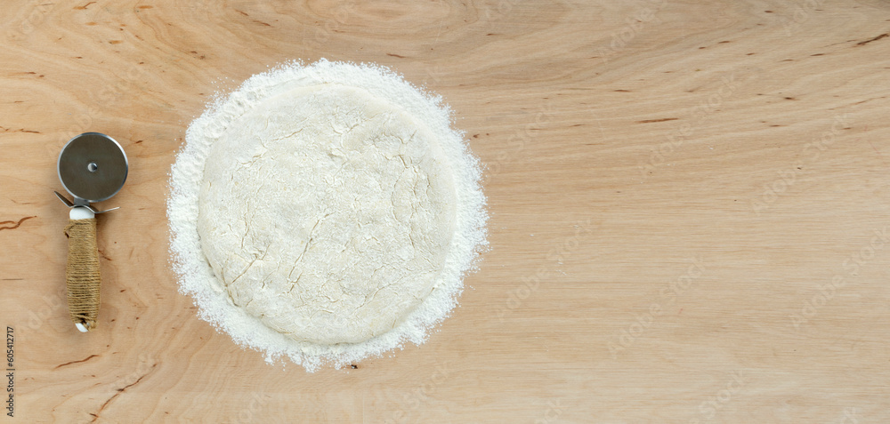Raw Ball of pizza doug or bread doug on wooden background with copy space, top view