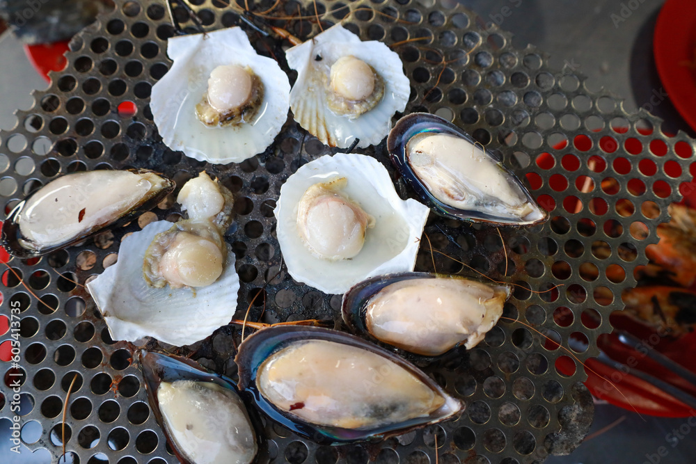 Grilled scallops, served on their shells, are a delectable seafood delicacy in Thailand. Grilled scallops, served on their shells, are a delectable seafood delicacy in Thailand.
