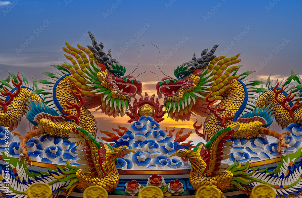 Colourful multicoloured dragon on top of a temple in Patong Phuket Thailand. beautiful blue green red of the scale dragons Colourful multicoloured dragon on top of a temple in Patong Phuket Thailand. beautiful blue green red of the scale dragons