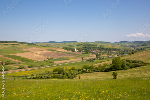 Idyllic landscape with a small village among the hills of Transylvania - Romania