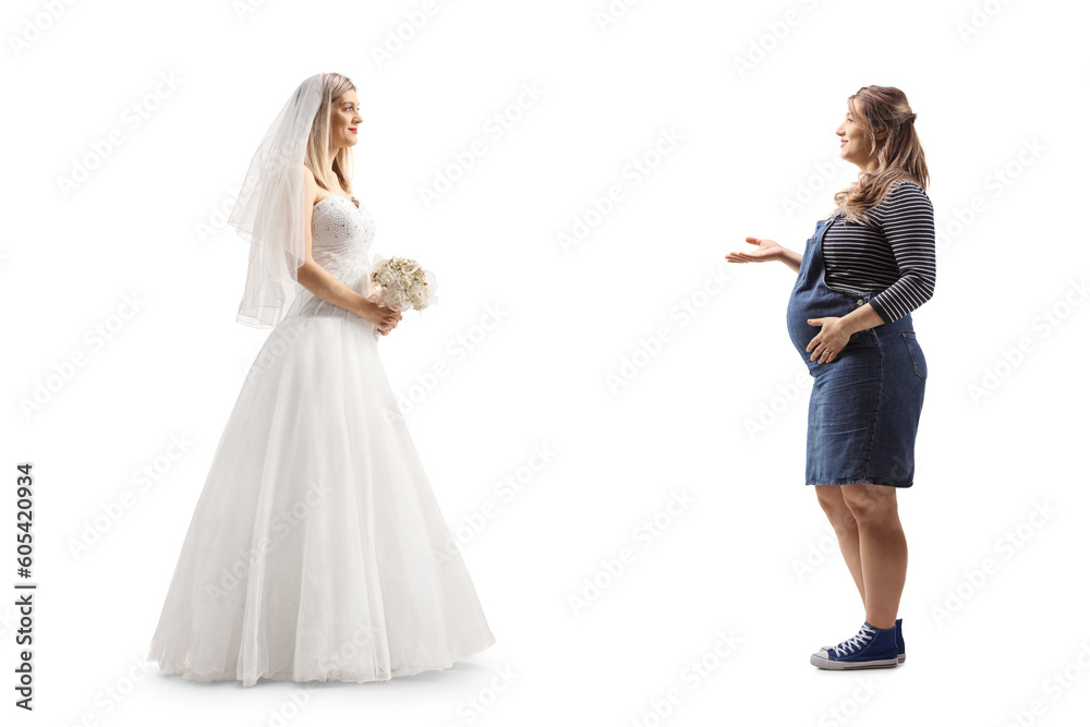Full length profile shot of a bride and a pregnant woman having a conversation
