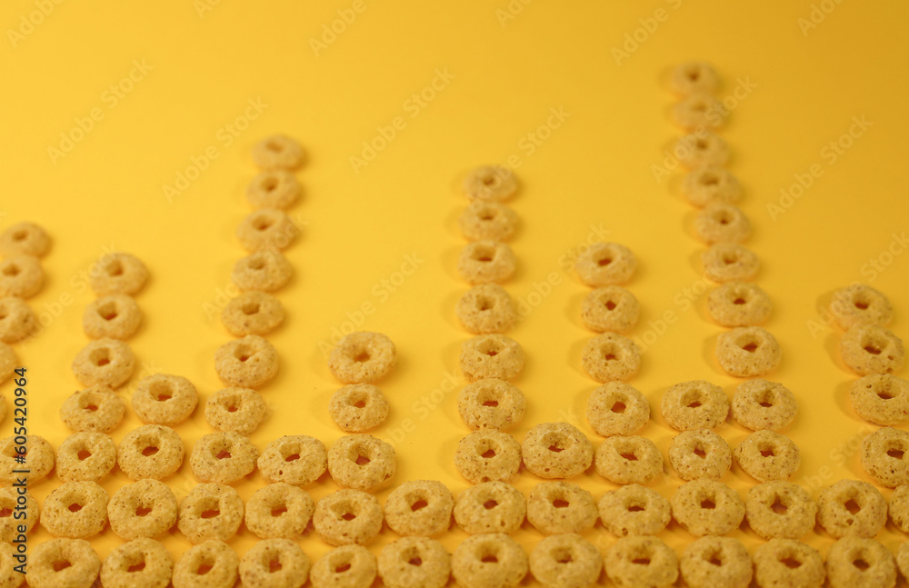 healthy corn flakes for breakfast in the form of pink and yellow rings in a transparent glass on a bright yellow background. for advertising labels splash screens signs flyers advertising
healthy corn flakes for breakfast in the form of pink and yellow rings in a transparent glass on a bright yellow background. for advertising labels splash screens signs flyers advertising