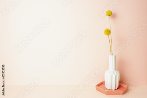Obraz na płótnie Vase of yellow craspedia golden ball flower on pink table. pink wall background. copy space w salonie