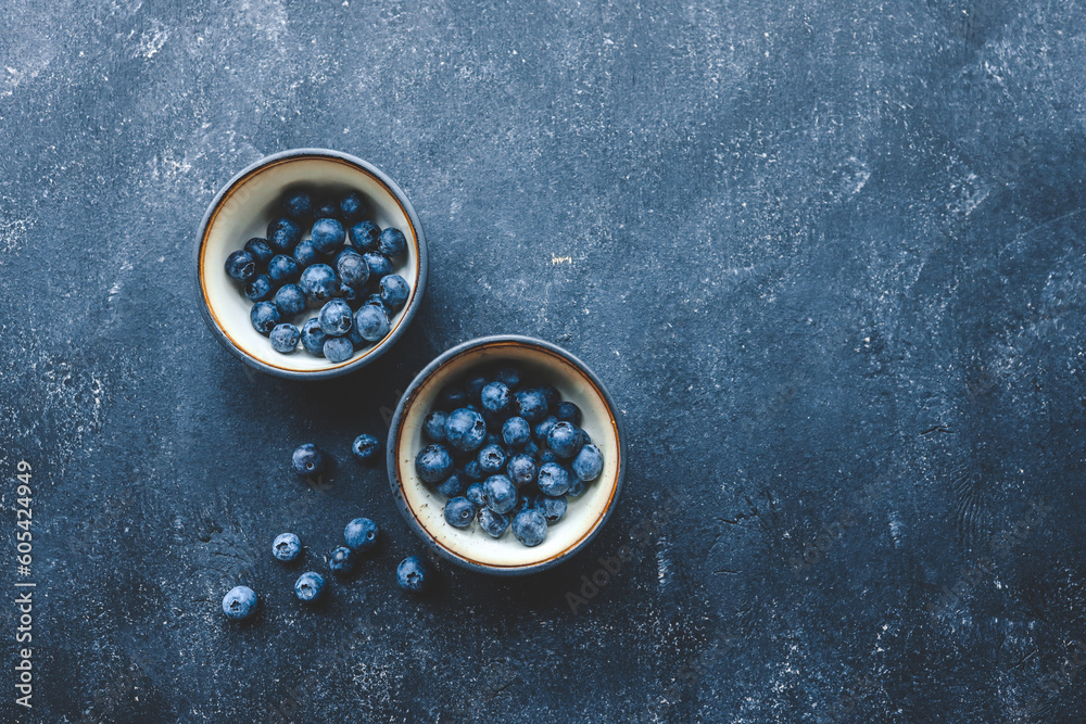Fresh juicy blueberries in plates on a dark background top view Fresh juicy blueberries in plates on a dark background top view