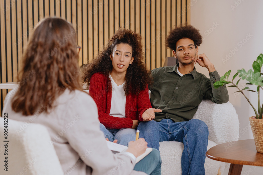 couple of man and woman at psychologist, taking care of mental health in relationship. joint therapy for solving communication problems in family. moral support for young African Americans married couple of man and woman at psychologist, taking care of mental health in relationship. joint therapy for solving communication problems in family. moral support for young African Americans married