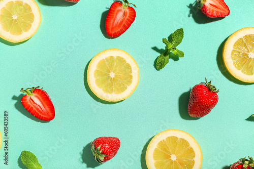 Fototapeta Naklejka Na Ścianę i Meble -  Fresh strawberries with lemon and mint on turquoise background