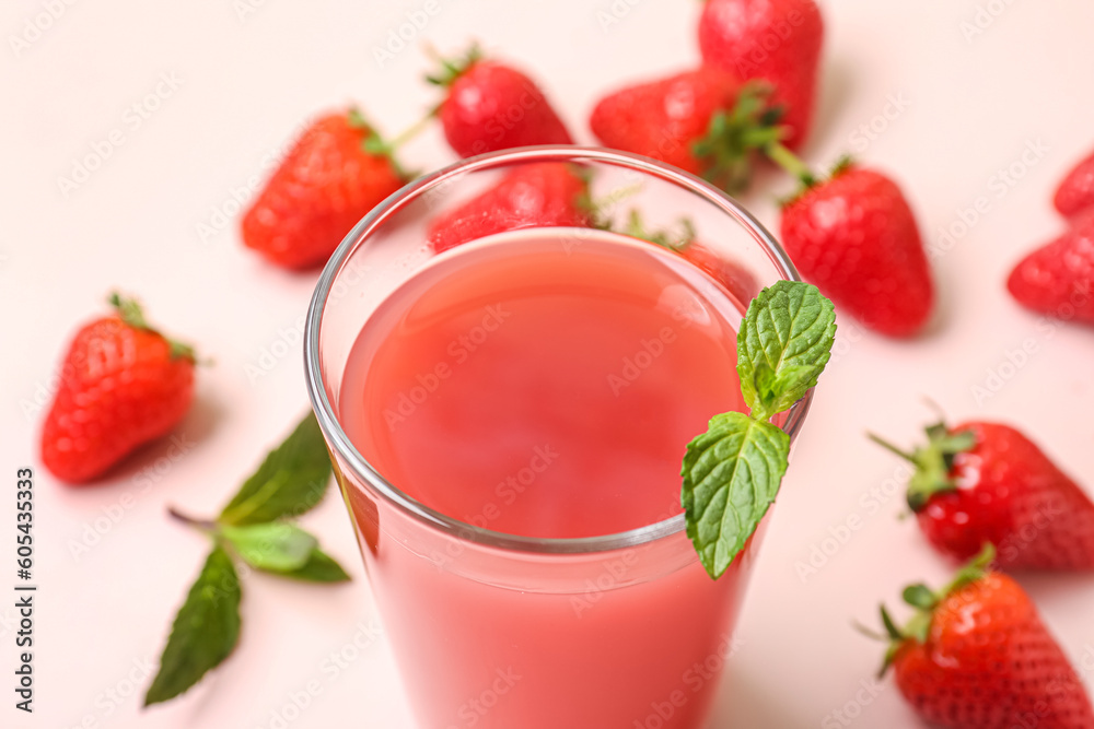 Glass of tasty strawberry juice on white table Glass of tasty strawberry juice on white table