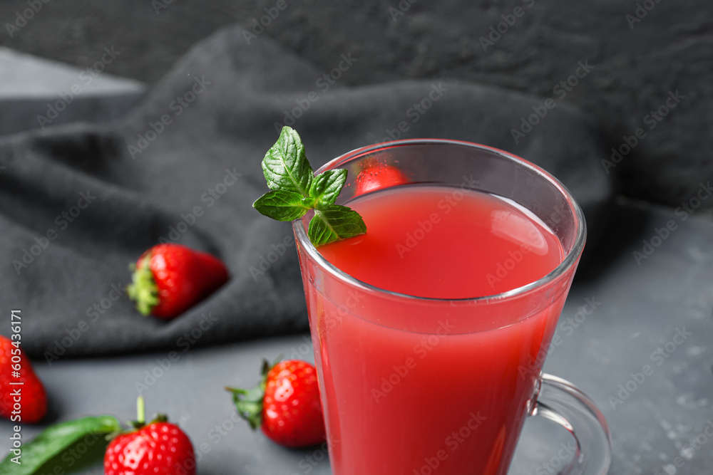 Glass of tasty strawberry juice on blue table Glass of tasty strawberry juice on blue table