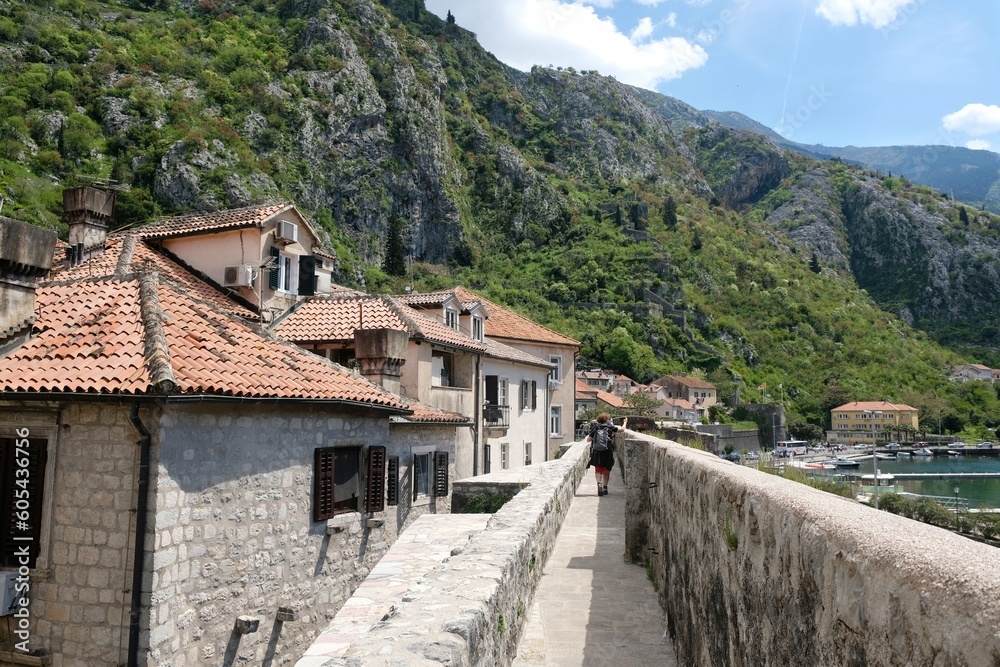 Fortress wall in Kotor, Montenegro. Kotor is a beautiful historic city on the Unesco list. Silhouettes of walking people on wall.