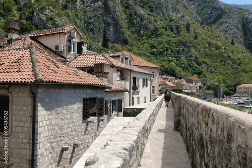 Fortress wall in Kotor, Montenegro. Kotor is a beautiful historic city on the Unesco list. Silhouettes of walking people on wall.