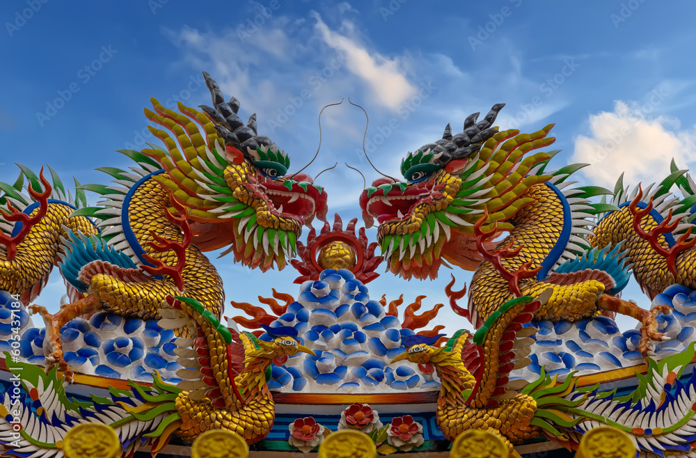 Colourful multicoloured dragon on top of a temple in Patong Phuket Thailand. beautiful blue green red of the scale dragons Colourful multicoloured dragon on top of a temple in Patong Phuket Thailand. beautiful blue green red of the scale dragons