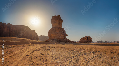 Rocky desert formations with sand in foreground, typical landscape of Al Ula, Saudi Arabia. Bright sun backlight, high resolution panorama