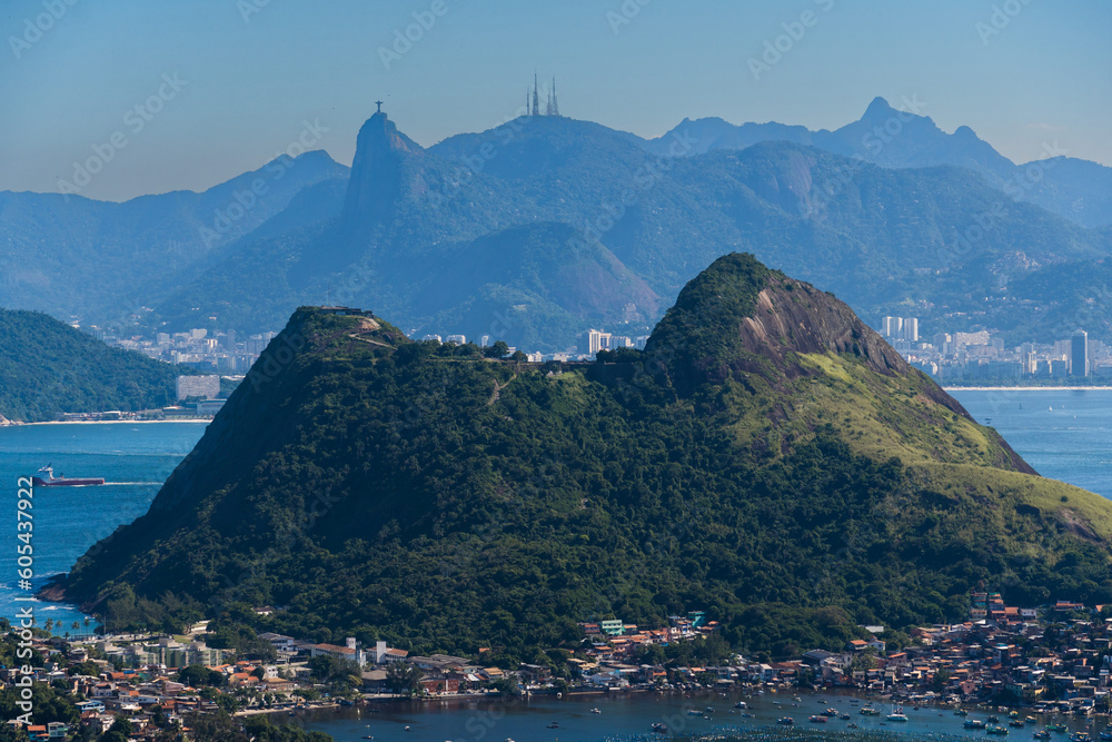 Beautiful view of Rio de Janeiro, Brazil seen from Niterói. With many hills in the background, Guanabara Bay, Jujuruba, Christ the Redeemer, beaches, pier with boats. Sunny day.