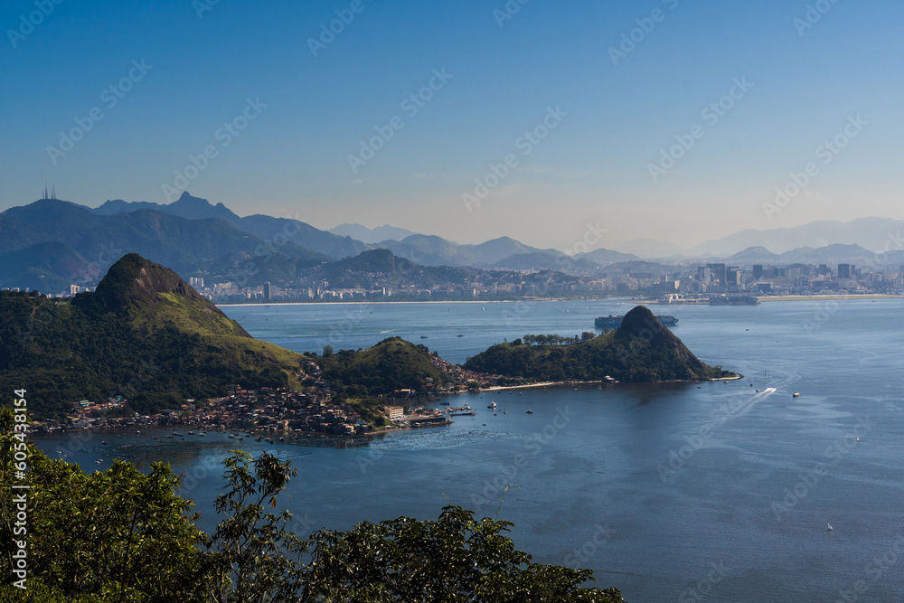 Beautiful view of Rio de Janeiro, Brazil seen from Niterói. With many hills in the background, Guanabara Bay, Jujuruba, beaches, pier with boats. Sunny day