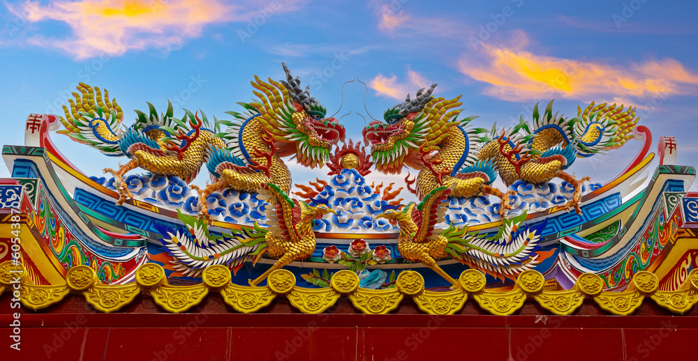 Colourful multicoloured dragon on top of a temple in Patong Phuket Thailand. beautiful blue green red of the scale dragons Colourful multicoloured dragon on top of a temple in Patong Phuket Thailand. beautiful blue green red of the scale dragons