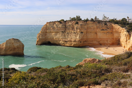 Limestone rock cliffs and rock in the Atlantic Ocean with a small sandy beach on a sunny winter day along the Seven Hanging Valleys Trail in southern Portugal. © Kari