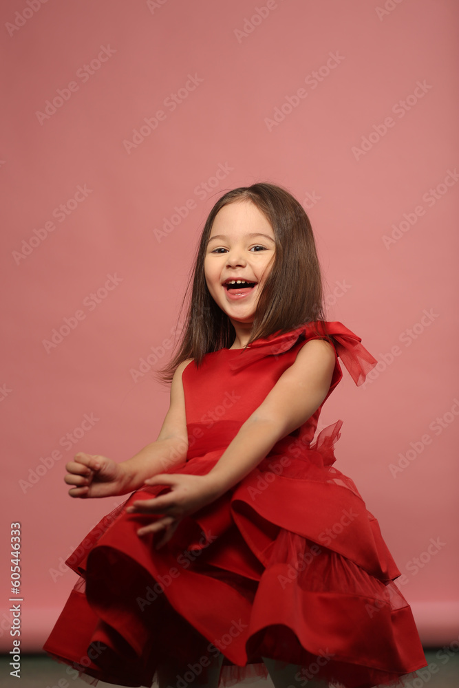 cute little girl in red dress happy closeup portrait on pink background cute little girl in red dress happy closeup portrait on pink background