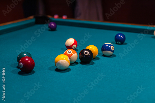 Pool (cue sports, billiards) concept image. Balls on a billiard table in a pool hall.