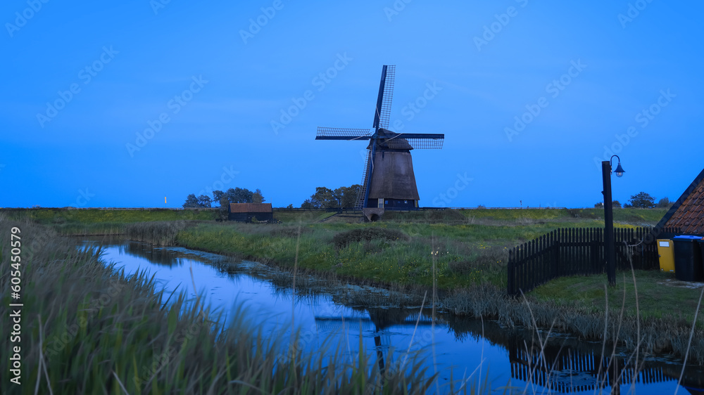 Ondermolen D windmill near Schermerhorn city in Netherlands during twilight.