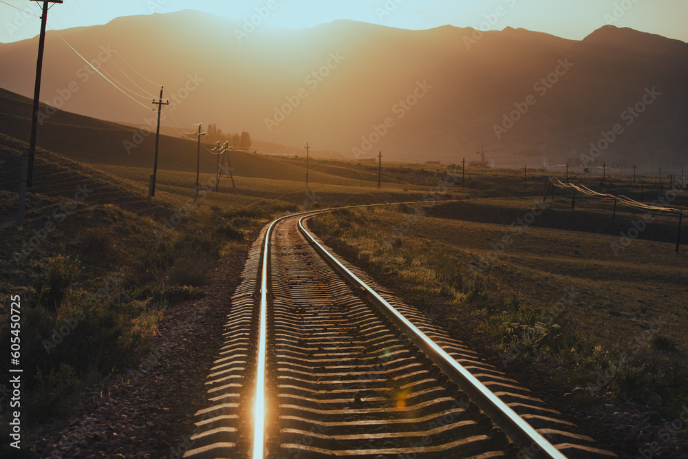 Railroad in the mountains at warm sunset light