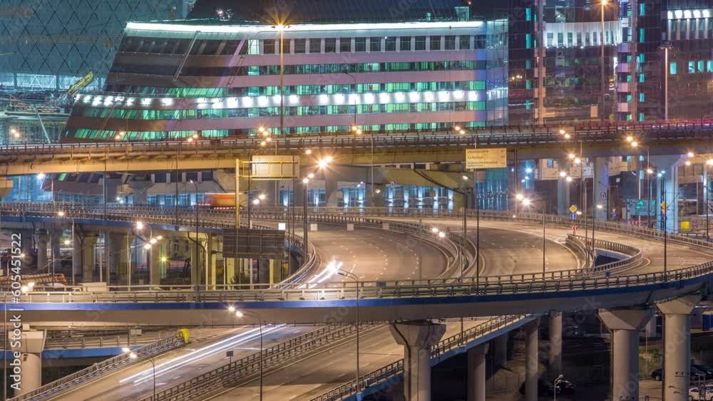 Large multi-level interchange of Third Ring Road intersection timelapse. Modern industrial cityscape of Moscow. Skyscrapers of the International Business Center on background. Aerial view from rooftop Large multi-level interchange of Third Ring Road intersection timelapse. Modern industrial cityscape of Moscow. Skyscrapers of the International Business Center on background. Aerial view from rooftop