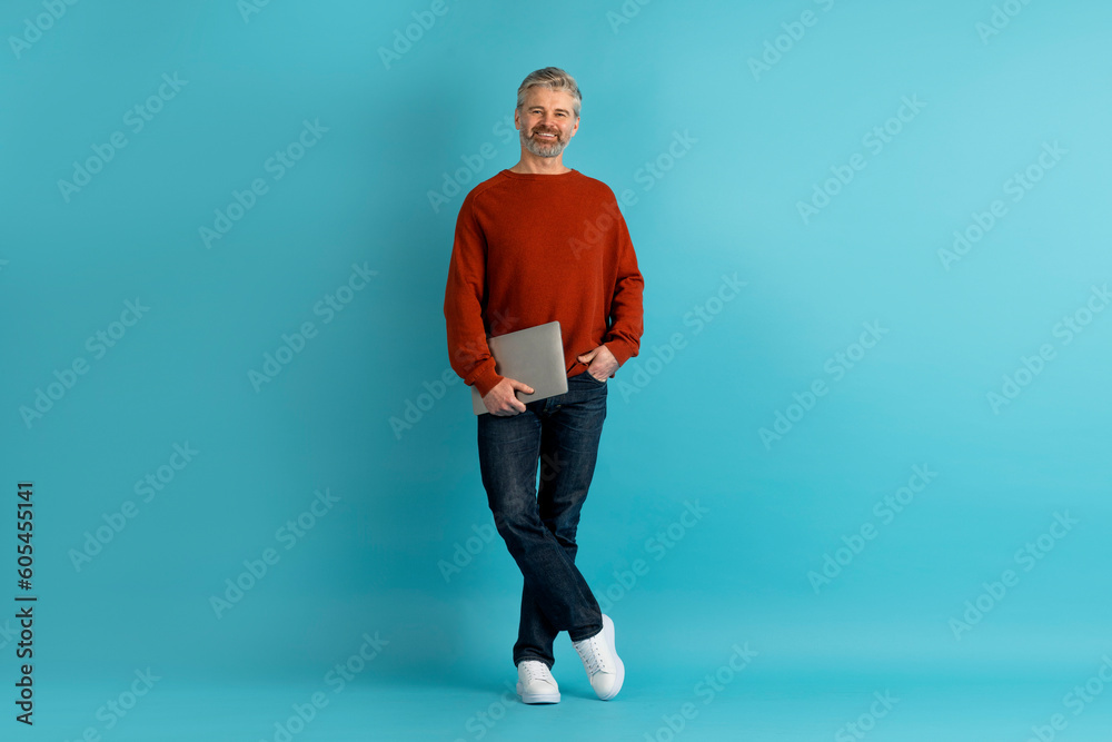 Happy handsome middle aged man remote worker posing with laptop Happy handsome middle aged man remote worker posing with laptop