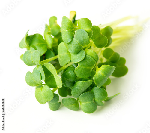 Bundle of broccoli sprouts on white background, close up . Microgreen superfood, vegan and healthy eating concept.