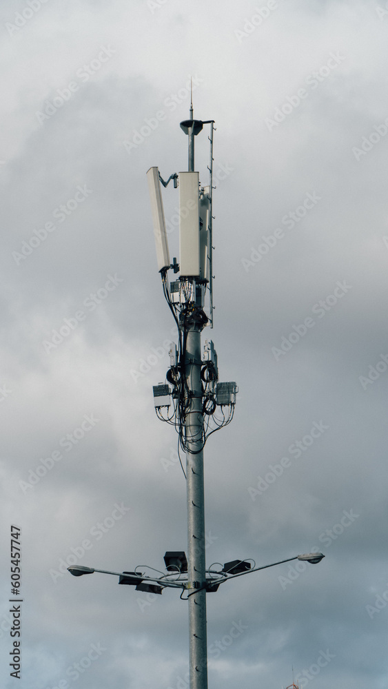 A lg antenna is shown against a cloudy sky.