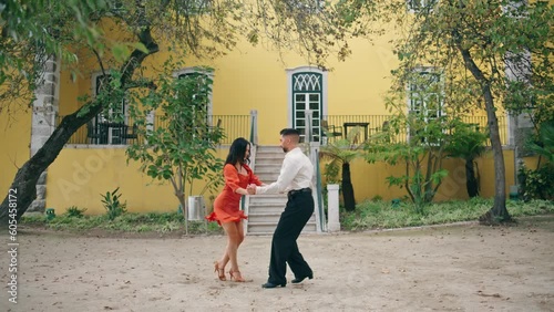 Couple samba dancers performing energetic dance on street. Pair dancing latino.