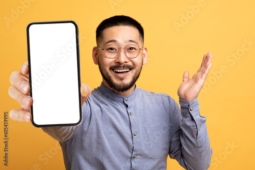 Amazing Offer. Excited Black Man Showing Blank Smartphone With White Screen