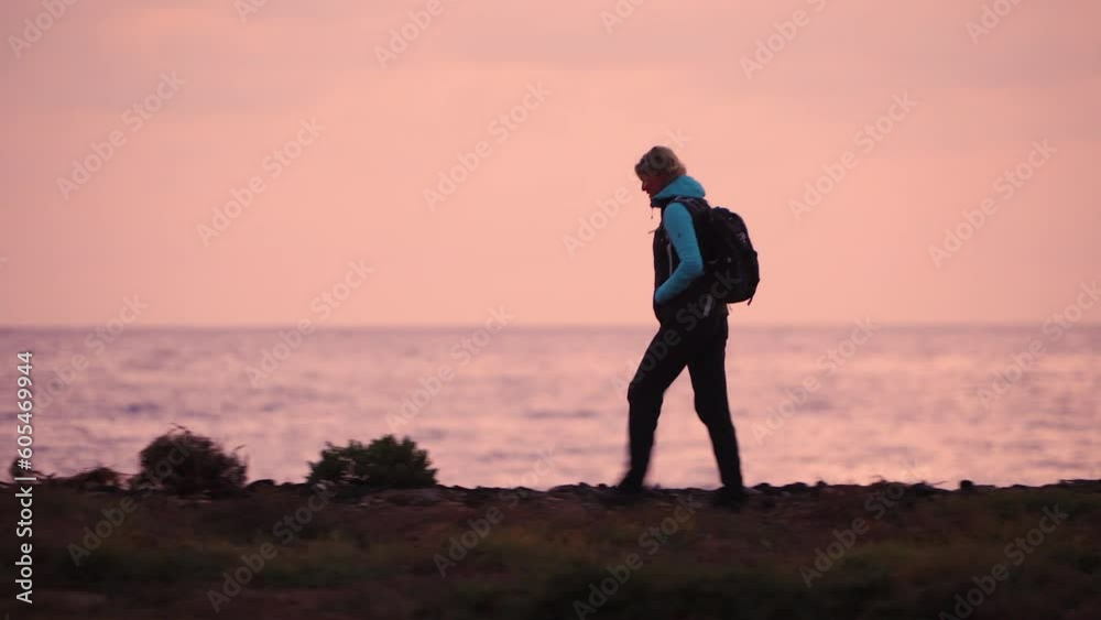 Female solo hiker walking desert ocean coastal path Female solo hiker walking desert ocean coastal path