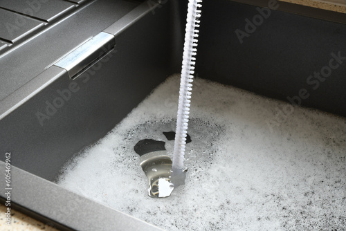 Overflowing kitchen sink, clogged drain.