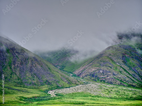 Mist and fog rolls down the mountain slopes along the wild and desolate Dalton Highway on the way to Deadhorse and Prudhoe Bay near the village of Nuiqsut in the North Slope Borough photo