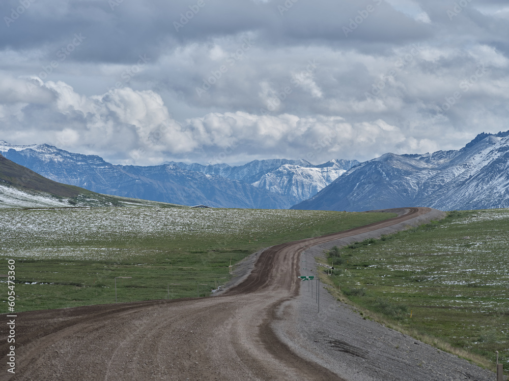 Dirt and gravel Dalton Highway looking south to the Brooks Range north of the village of Nuiqsut Alaska