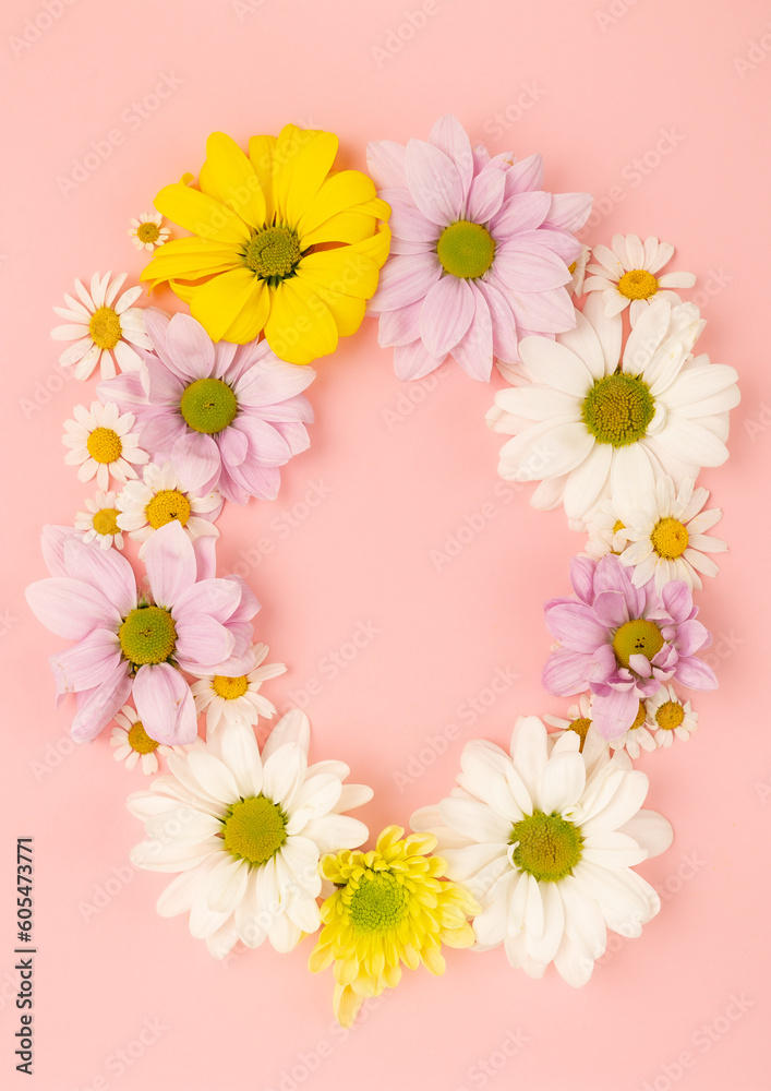 Frame of flowers on a pink background.