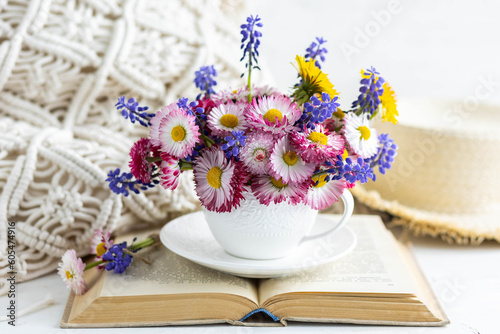 Greeting card for Women s or Mother s Day  8th of March. Beautiful spring or summer floral composition with daisy camomile flowers in a white cup for countryside table decor. Wooden background